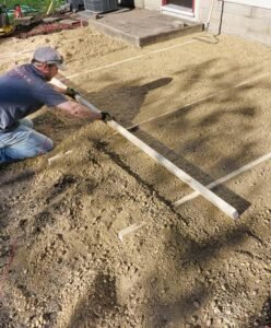 leveling coarse sand bedding layer before laying pavers